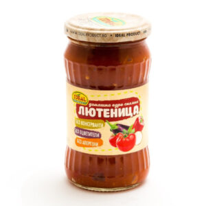 The image shows a jar of Lyutenitsa, a Bulgarian vegetable relish. The jar has a ribbed design and a metal lid. The label features images of tomatoes and peppers, and text indicating the product is made by Ideal Product. It highlights that the contents are free from preservatives, artificial colors, and allergens.