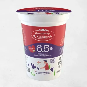 The image is of a yogurt container. The container has a red and purple color scheme with a white background. The lid shows similar colors, featuring the brand logo. The front label displays 6.5% prominently, indicating the fat content. There's an illustration of a shepherd and sheep, along with some decorative elements like flowers. The product text is in Bulgarian, mentioning it as Bulgarian sheep's milk yogurt. The container's weight is indicated as 400g.
