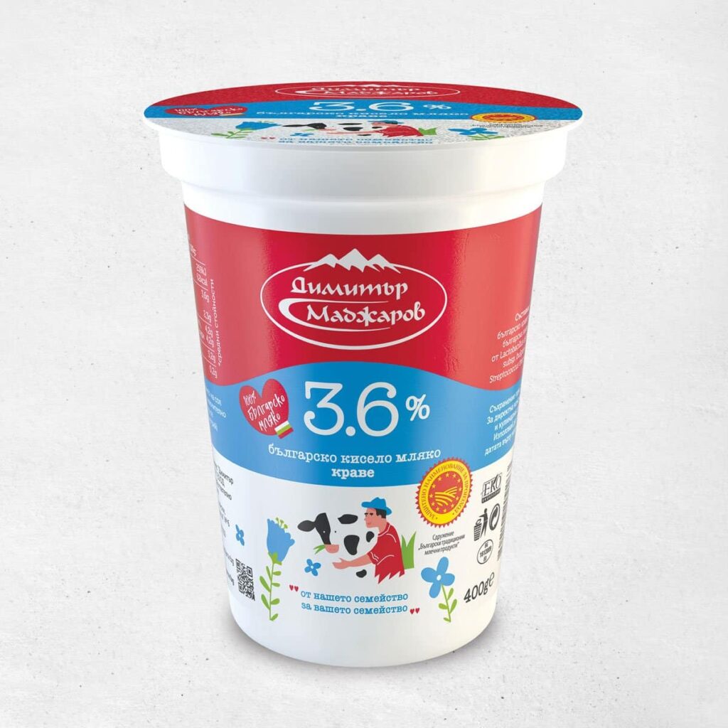 The image shows a container of Bulgarian yogurt with a 3.6% fat content. The packaging features a red and blue color scheme. The red area displays the brand's logo, while the blue section prominently highlights 3.6%. Below, there are illustrations of a farmer with a cow and various flowers. Several certifications and labels are visible, indicating quality standards. The container is a 400g size.