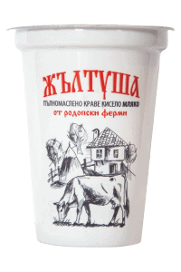 The image shows a white container of yogurt with Bulgarian text in red and black. The text includes ЖЪЛТУША at the top. Below, there is an illustrated design featuring a cow, a small house, and rural scenery. The product appears to involve dairy or milk from Rodopi farms.