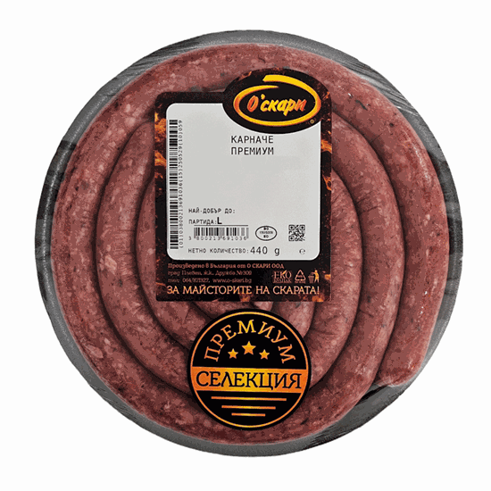 The image shows a circular pack of sausage, coiled neatly inside a clear plastic container. On top, there's a label with text in Bulgarian, including Карначе ПРЕМИУМ indicating a premium product. The packaging is marked with branding, a barcode, and information about the net weight of 440 grams. The design includes stars and a СЕЛЕКЦИЯ label suggesting a premium selection.