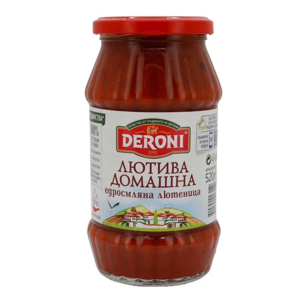 The image shows a glass jar of Deroni brand product with a red screw-on lid. The jar contains a red-colored spread or sauce. The label has text in a foreign language (Cyrillic script), featuring the brand name Deroni prominently in red and white. Below the brand name, there is a picture of a scenic countryside with houses and hills. The volume indicated on the label is 520 grams.