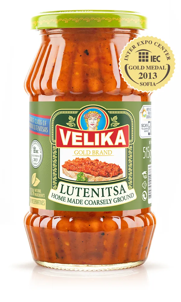 The image shows a jar of Velika brand Lutenitsa, a homemade, coarsely ground sauce. The jar has a green lid and a green label featuring an illustration of a bearded figure. The label highlights that the product contains 100% natural ingredients with no preservatives. It has won a gold medal at the IEC in Sofia in 2013. The jar contains 515 g of the product, which is visible through the glass as a red, chunky sauce.