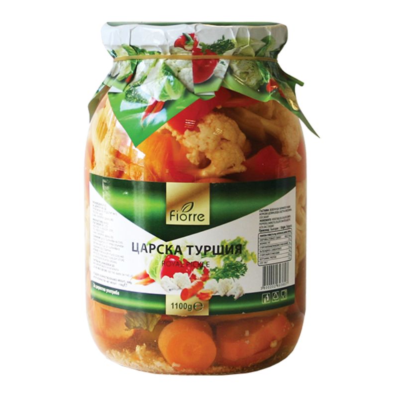 This is an image of a jar labeled Fiore. The jar is filled with a mix of pickled vegetables, including cauliflower, carrots, and peppers. The label features the text Царска туршия and an image of vegetables. The lid is covered with decorative paper, showing more vegetables. The net weight is marked as 1100g.