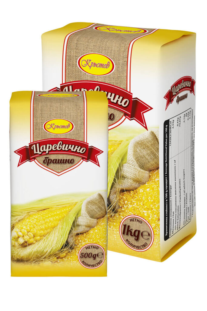 The image shows two packages of corn flour. Both have a yellow and white design with a red banner and a depiction of corn on the cob and cornmeal. The packaging features text in Cyrillic, with the brand name in an oval yellow section. One package indicates a net weight of 500g, and the other 1kg. There is also a textured pattern resembling burlap on parts of the packaging.