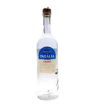 The image shows a clear glass bottle with a slender neck and a sealed cap. The label on the bottle reads Paralia Ouzo with a blue and cream color scheme. The bottle appears to contain a clear liquid.