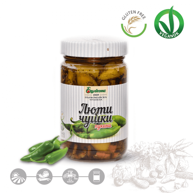 The image features a jar of roasted hot peppers labeled in a language that resembles Bulgarian. The jar has a white-striped label with green peppers pictured on it. There are Gluten Free and Vegan symbols at the top right. Below the jar, there are small icons, possibly indicating benefits or features of the product. Additionally, there are some green peppers placed beside the jar and an artistic design with vegetables at the bottom right.