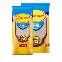 The image shows two packages of rice. Each package has a blue and yellow design with text in a script font. There is a logo featuring a chef and the weight of the packages is indicated—500 grams and 1 kilogram. The packaging has a clear section that allows the rice inside to be partially visible.