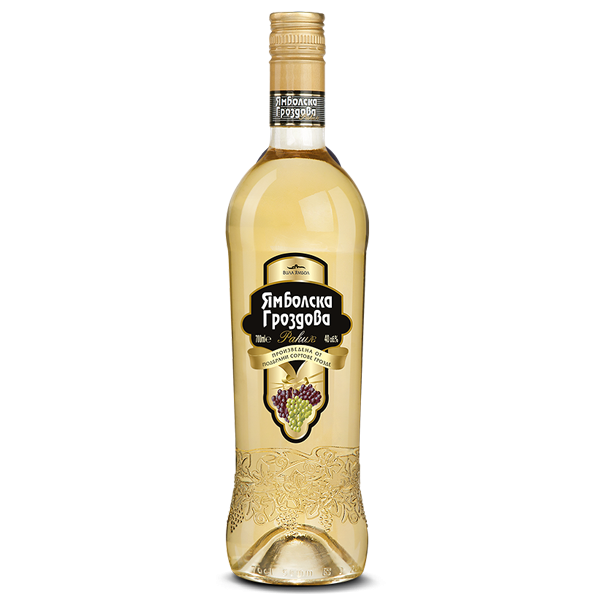 This is an image of a bottle of Ямболска Гроздова rakia. The glass bottle contains a light-colored spirit and features a decorative label with Cyrillic writing. The label includes an image of grapes, indicating the beverage is grape-based. The lower part of the bottle has an embossed floral design, adding a decorative touch.