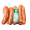 The image shows a package of four sausages wrapped in clear plastic. There is a white and green label on the package that appears to indicate the product information. The sausages are arranged horizontally and are visibly slick with moisture inside the packaging.